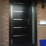 Modern Fiberglass Doors with Stainless Steel strips and frosetd side lite installed in Richmond Hill by Modern Doors