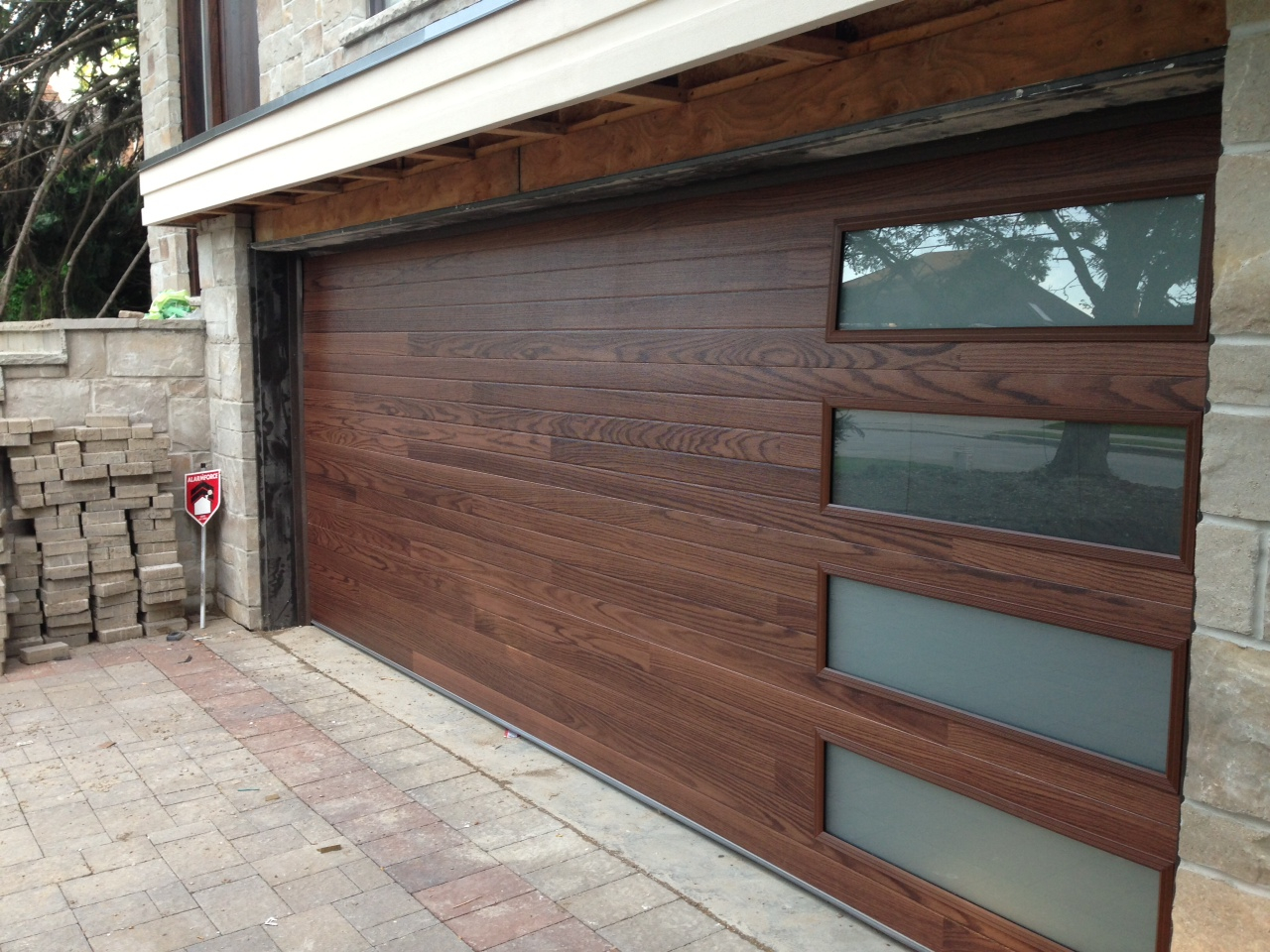 Custom Modern Contemporary Oversized Garage Door installed in custom new construction in Toronto