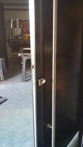 Modern Exterior Front Door with Stainless Steel Hand Bar and multi point locks manufactured by  by www.modern-doors.ca