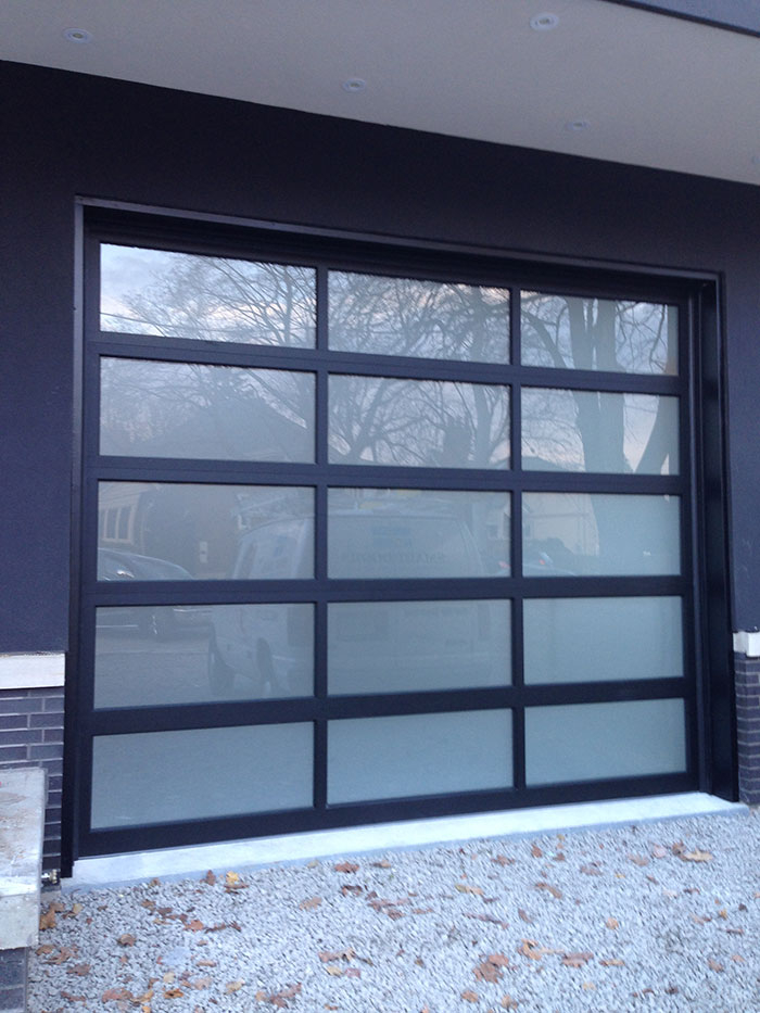 Oversized Aluminum Frosted Glass Garage Door in Custom Home in Oakville by Modern Doors