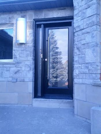 SIngle Modern Front Door with Side lite and frosted glass backing with lazer cut design and multipoint locks installed in Thornhill by modern-doors.ca